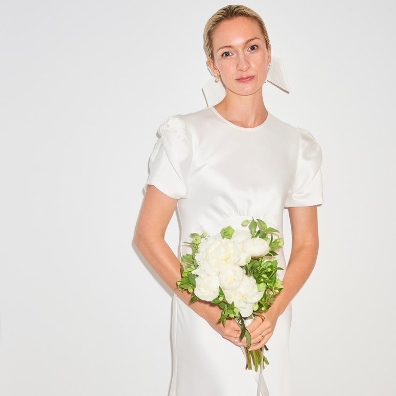 Image may contain: Clothing, Apparel, Human, Person, Plant, Flower, Blossom, Female, Flower Bouquet, and Flower Arrangement